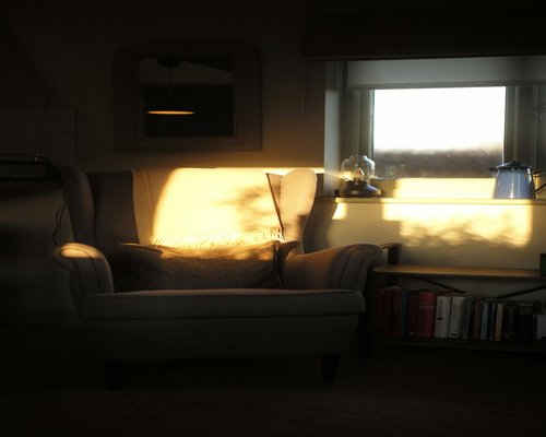 A calm reading place located near a bright window