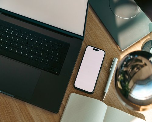 Phone notebook and water on an organized work desk
